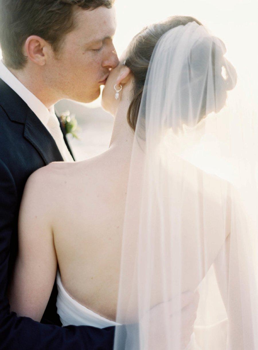 A groom kissing the bride on the cheeks - Jen Huang work on the SDE feature on being an introvert in the photography industry