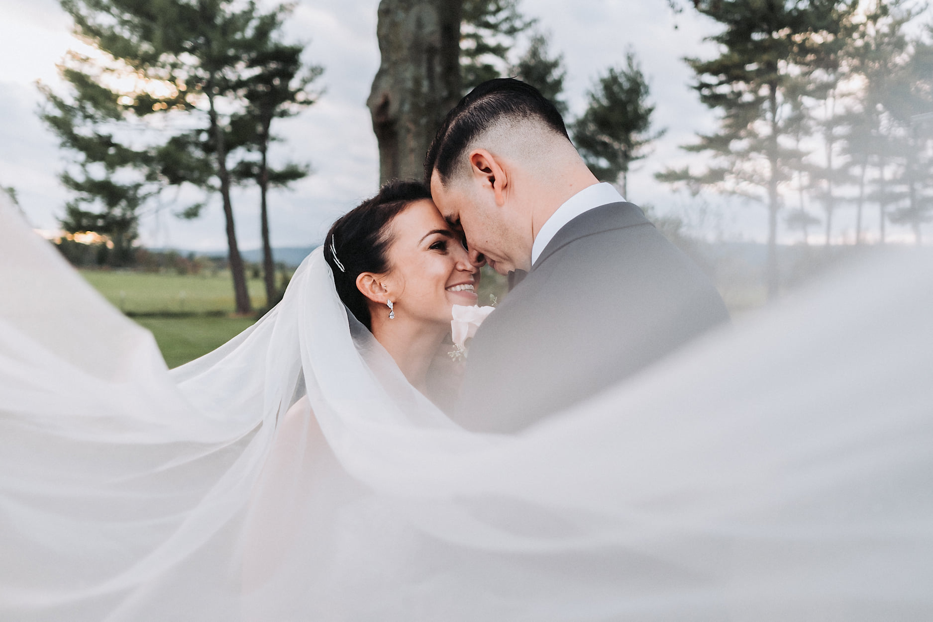 A through-the-veil shot of a couple captured by John Branch IV Photography