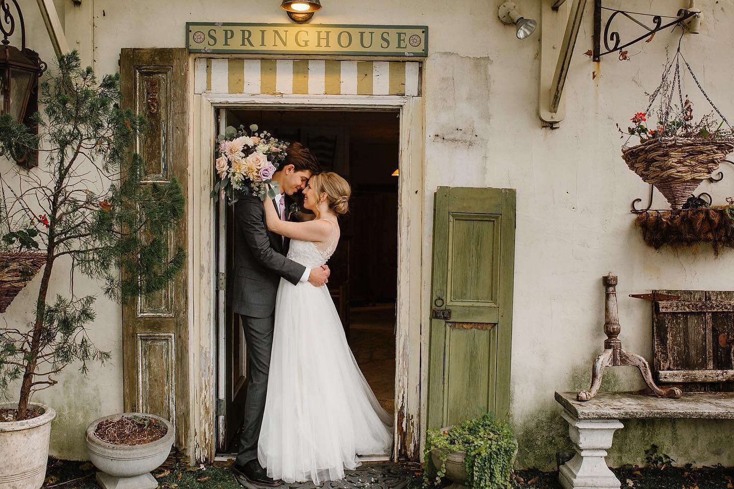 couple leaning together in doorway of a springhouse 