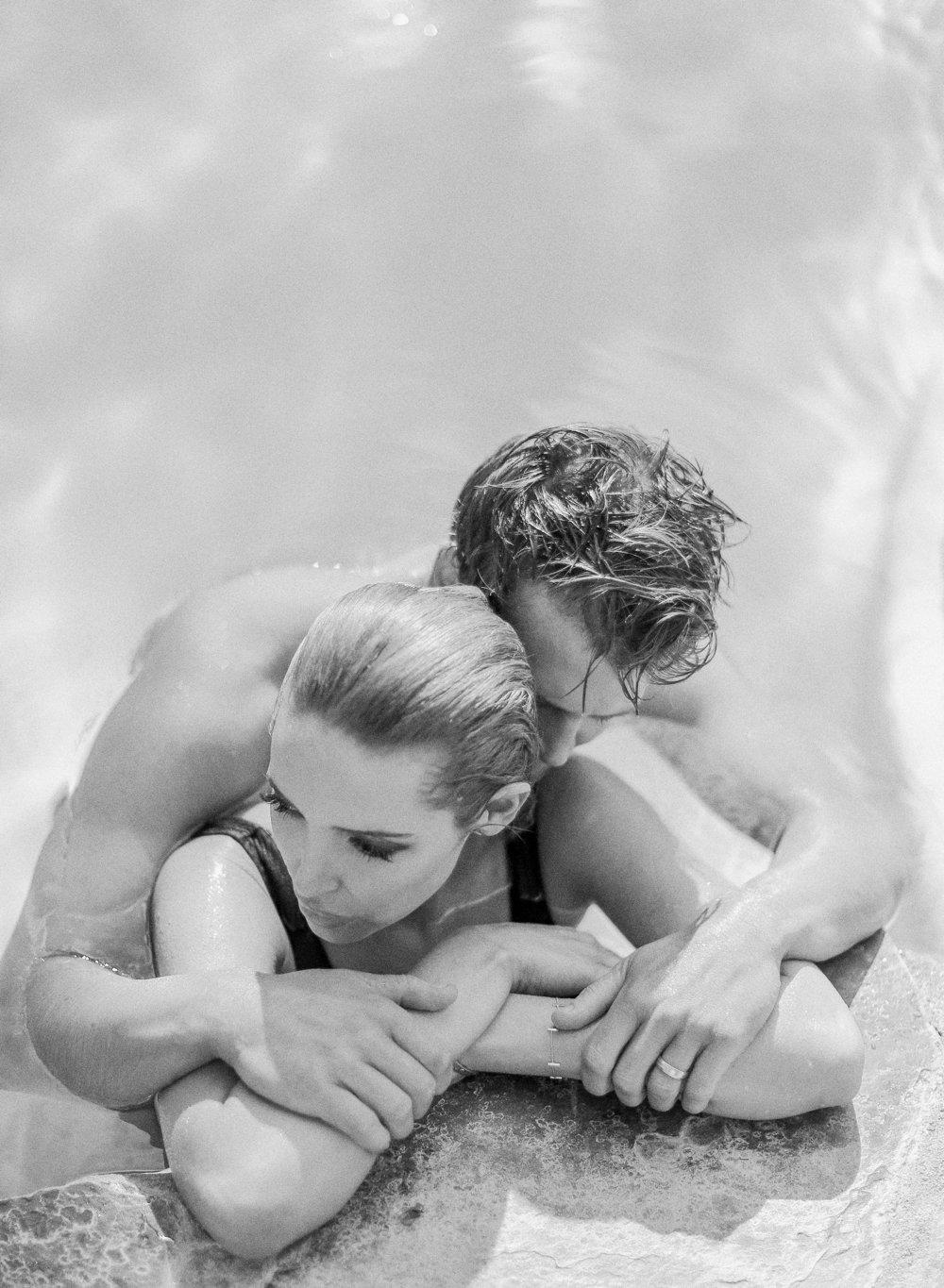 Black and white portrait of a couple in a swimming pool