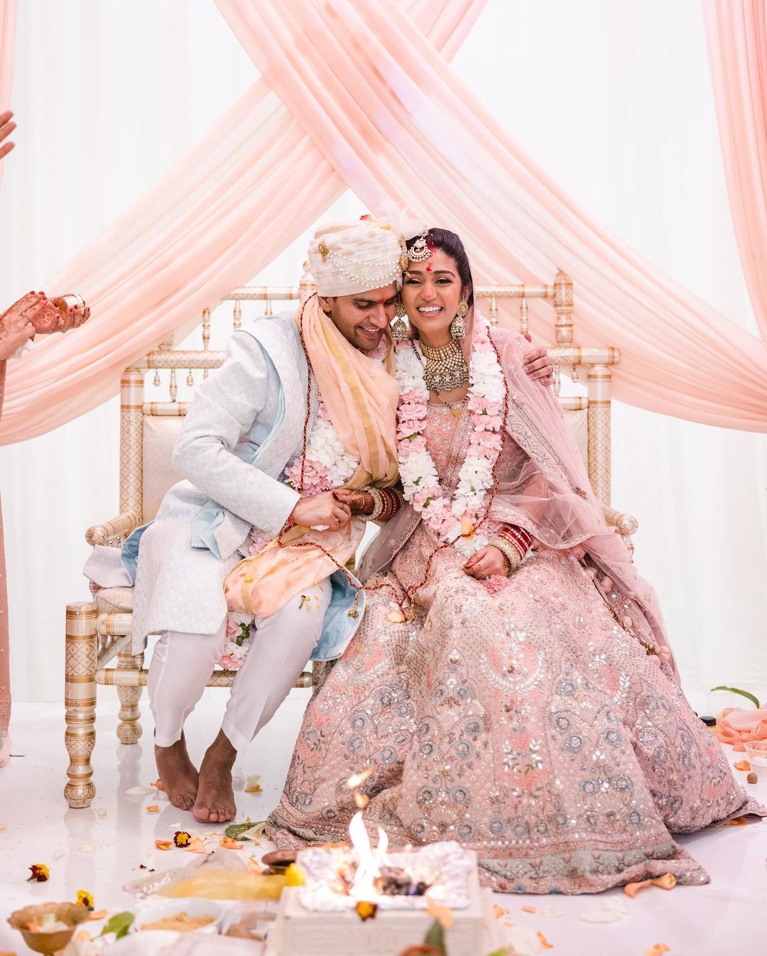 a wedding couple in their wedding attire having a laugh during the ceremony