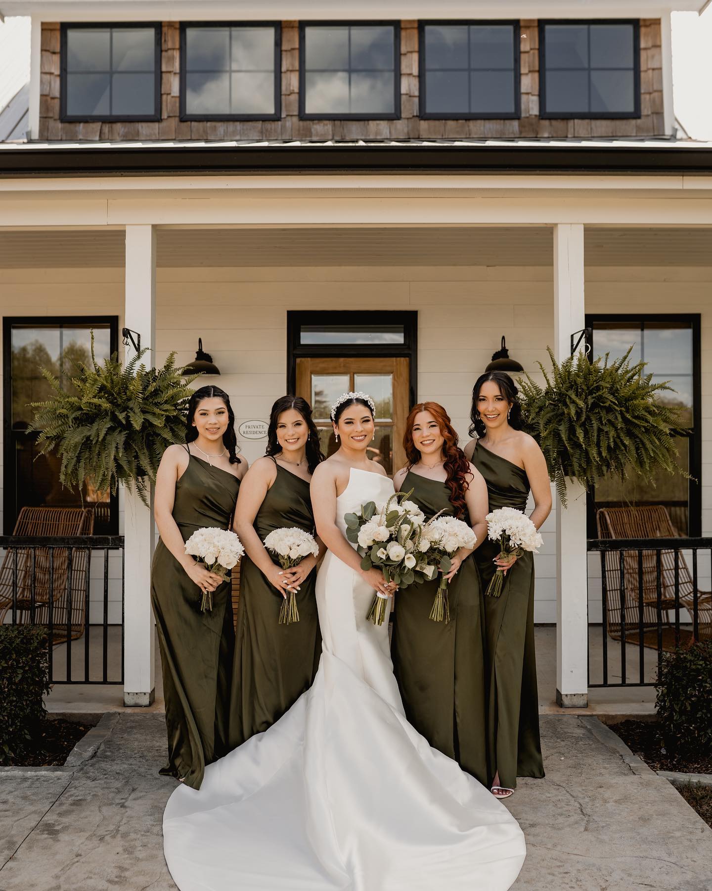 a bride and her bridesmaids posing with the bouquets in hands