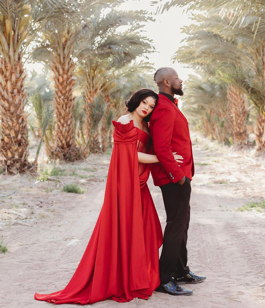 a bride embracing the groom from behind in between a road with trees around