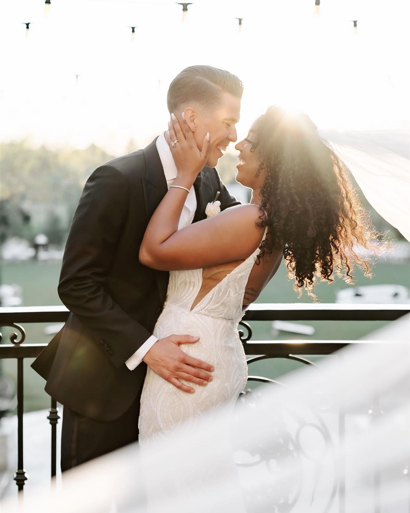 a wedding groom holding the bride while she is leaning back looking at each other