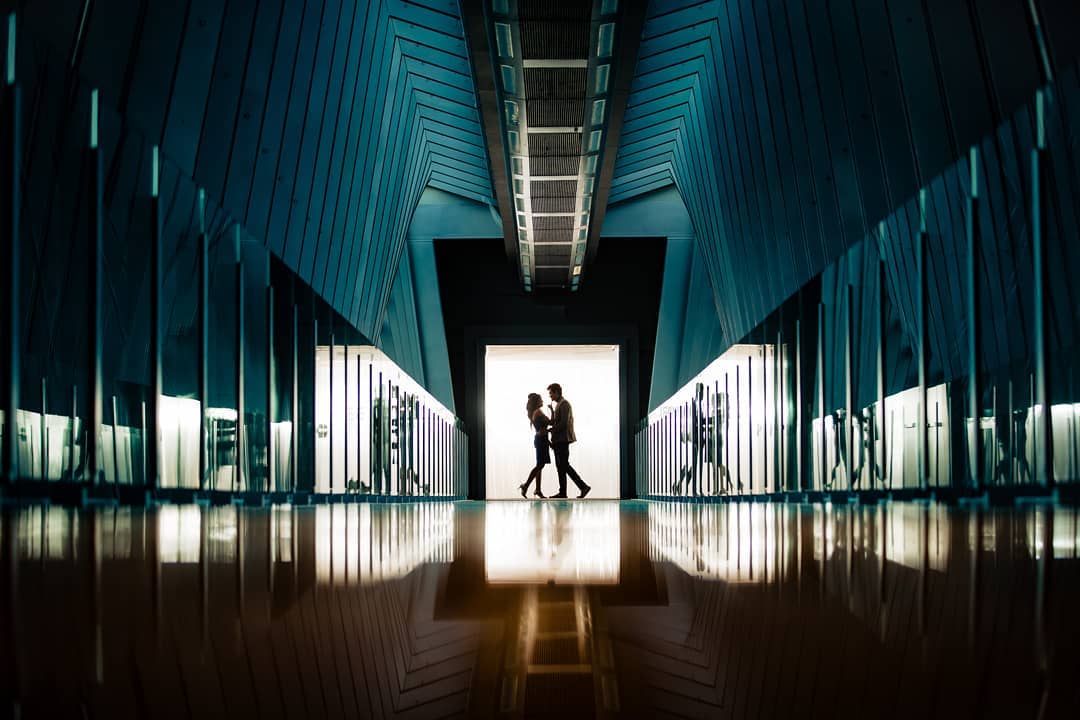 Silhouette of a couple posing at the end of a hallway