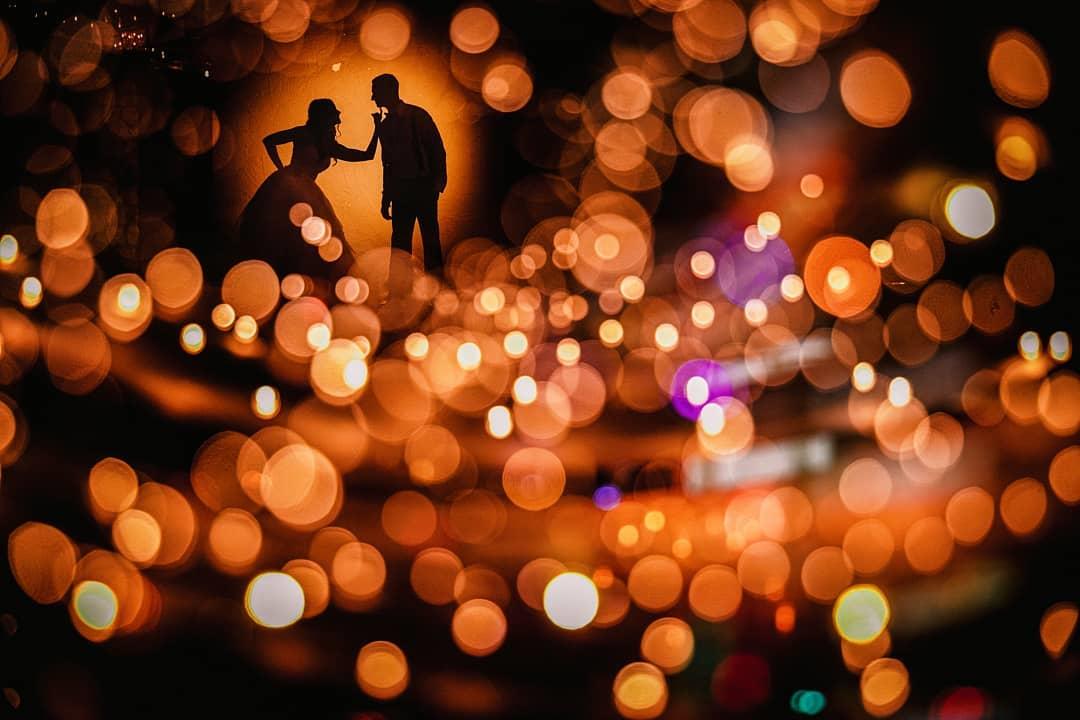 Silhouette image of a bride and groom with a bokeh background - Stellar example of how to shoot a wedding by Robb McCormick