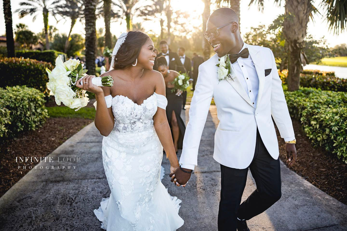 a wedding couple laughing and looking at each other during their grand wedding exit