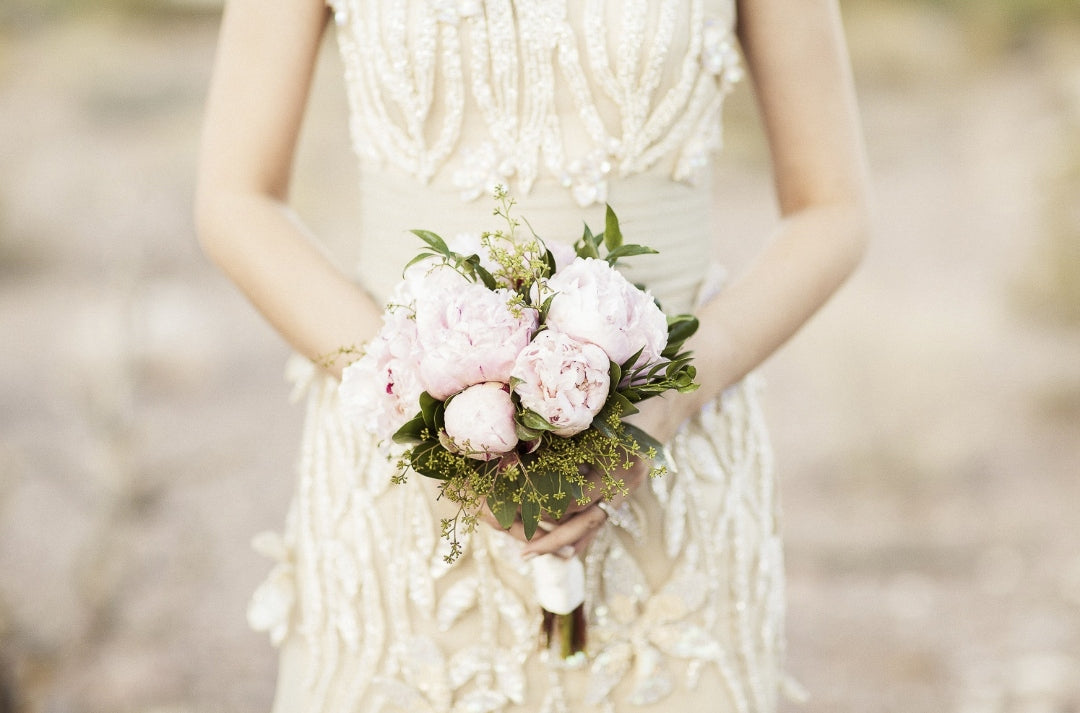 Mid closeup shot of a bride holding bridal bouquet in her hands