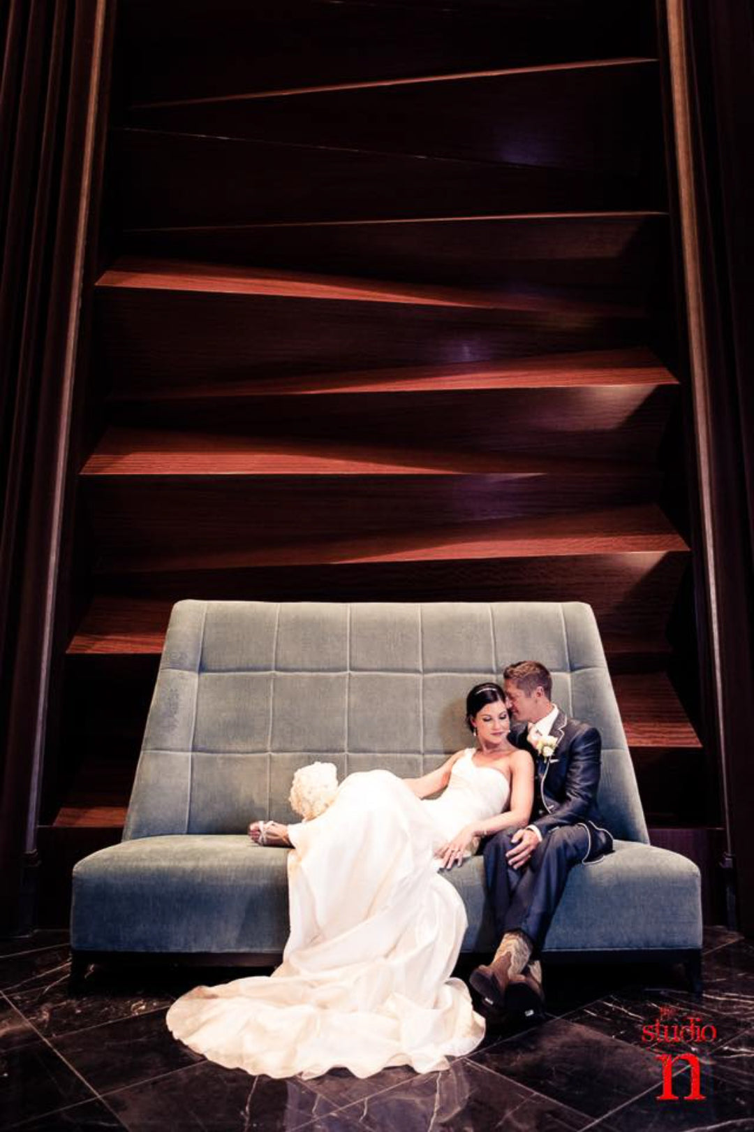 Bride and groom posing on a couch