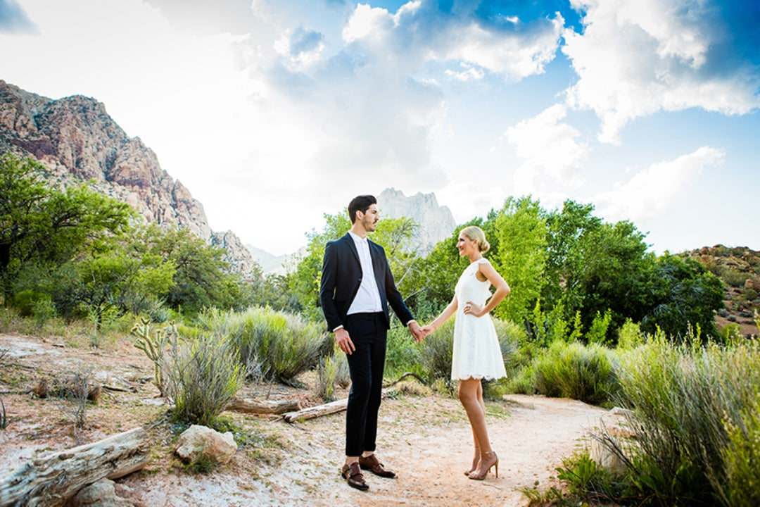 A couple posing at an outdoor setting while holding hands