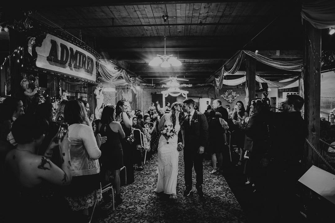 a wedding couple kissing during their grand exit