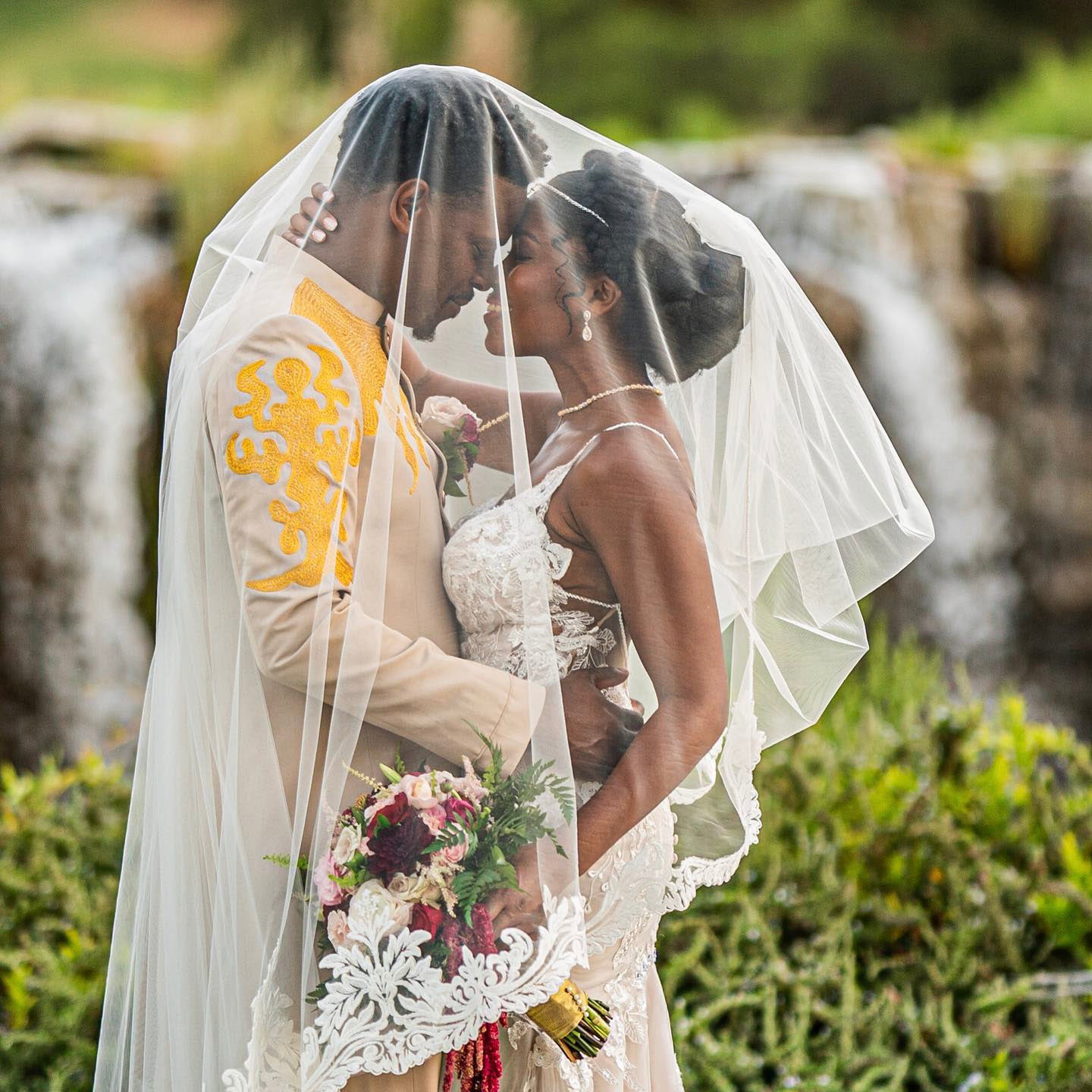 a newlywed couple sharing a close moment under the wedding veil