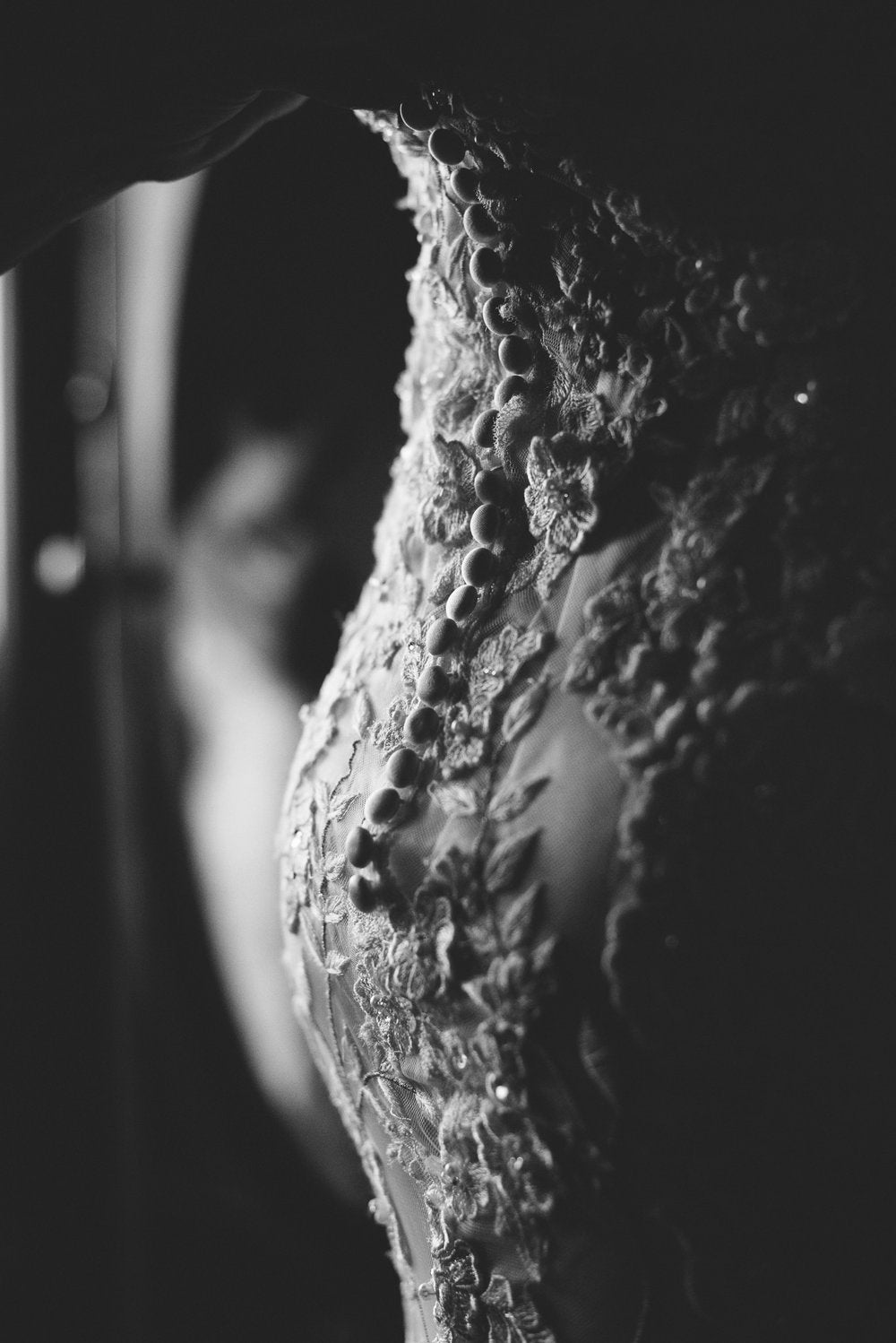 Black and white detail photo of the buttons on the wedding dress