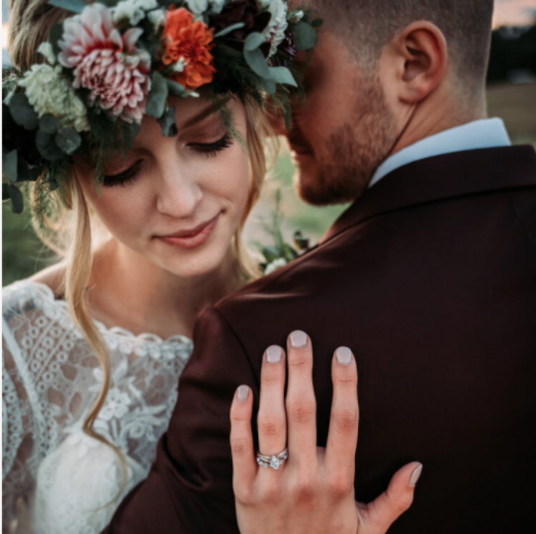 A portrait of a bride and groom hugging