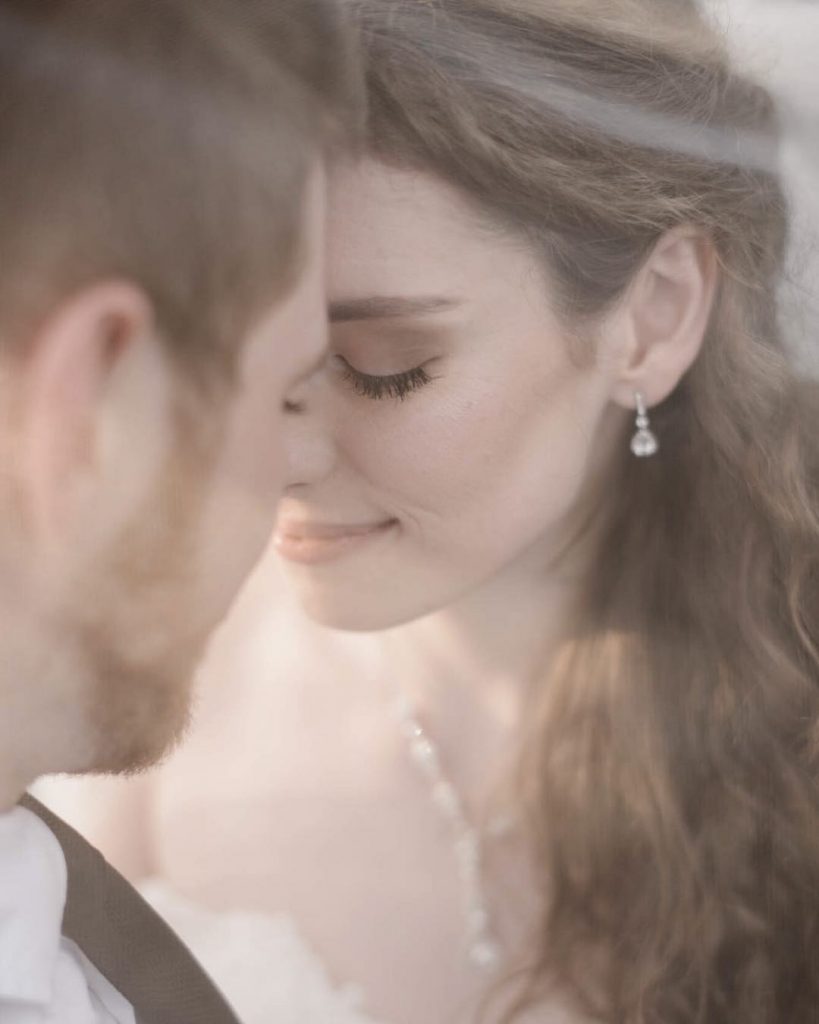 a wedding couple touching foreheads with each other