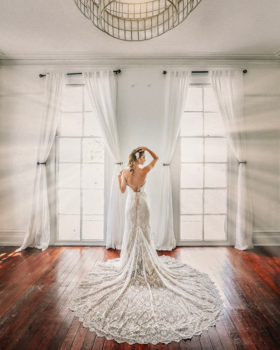 a bride in her beautiful wedding attire flaunting the train of the dress