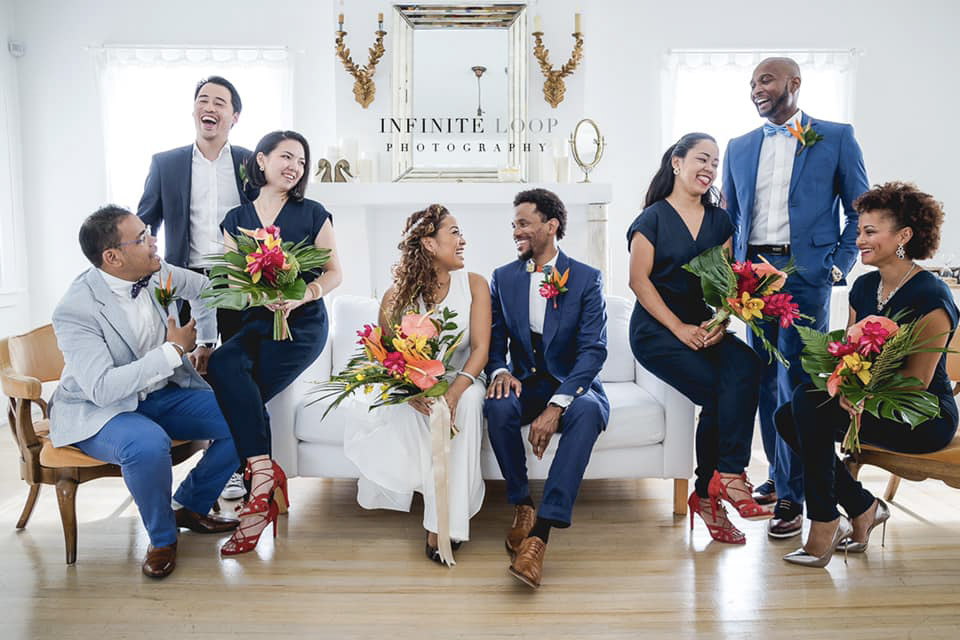 a wedding couple having an indoor moment with friends and family