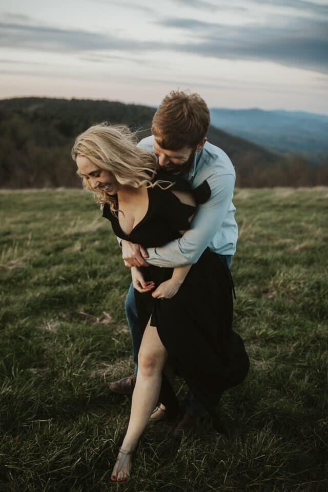 a groom embracing the bride from behind