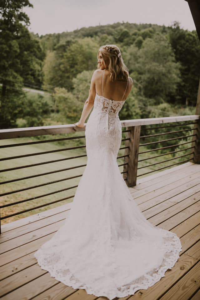 a bride standing on the balcony in her wedding attire