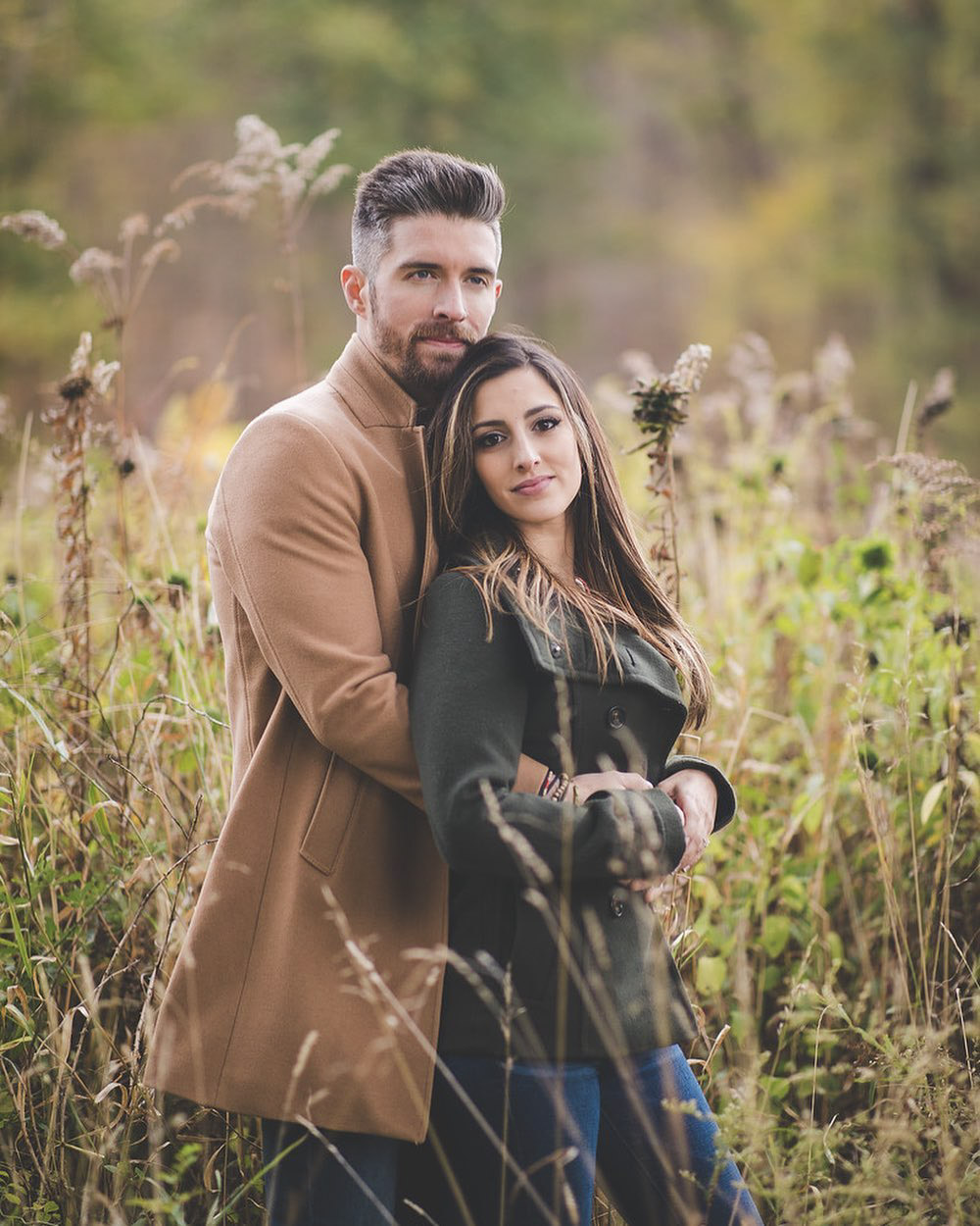 an engaged couple where the groom is embracing the bride from behind