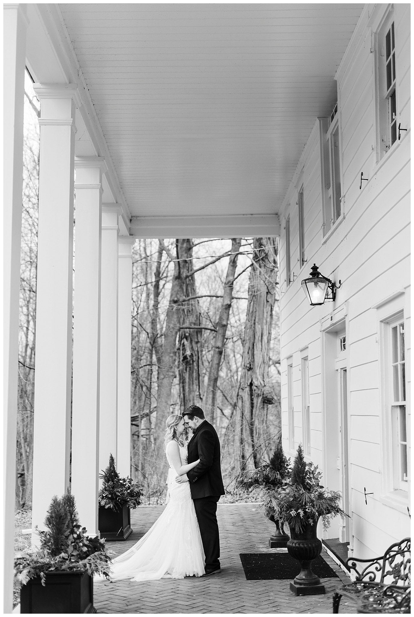 a wedding couple embracing each other on the porch