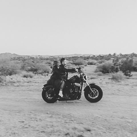 A couple riding a motorcycle 